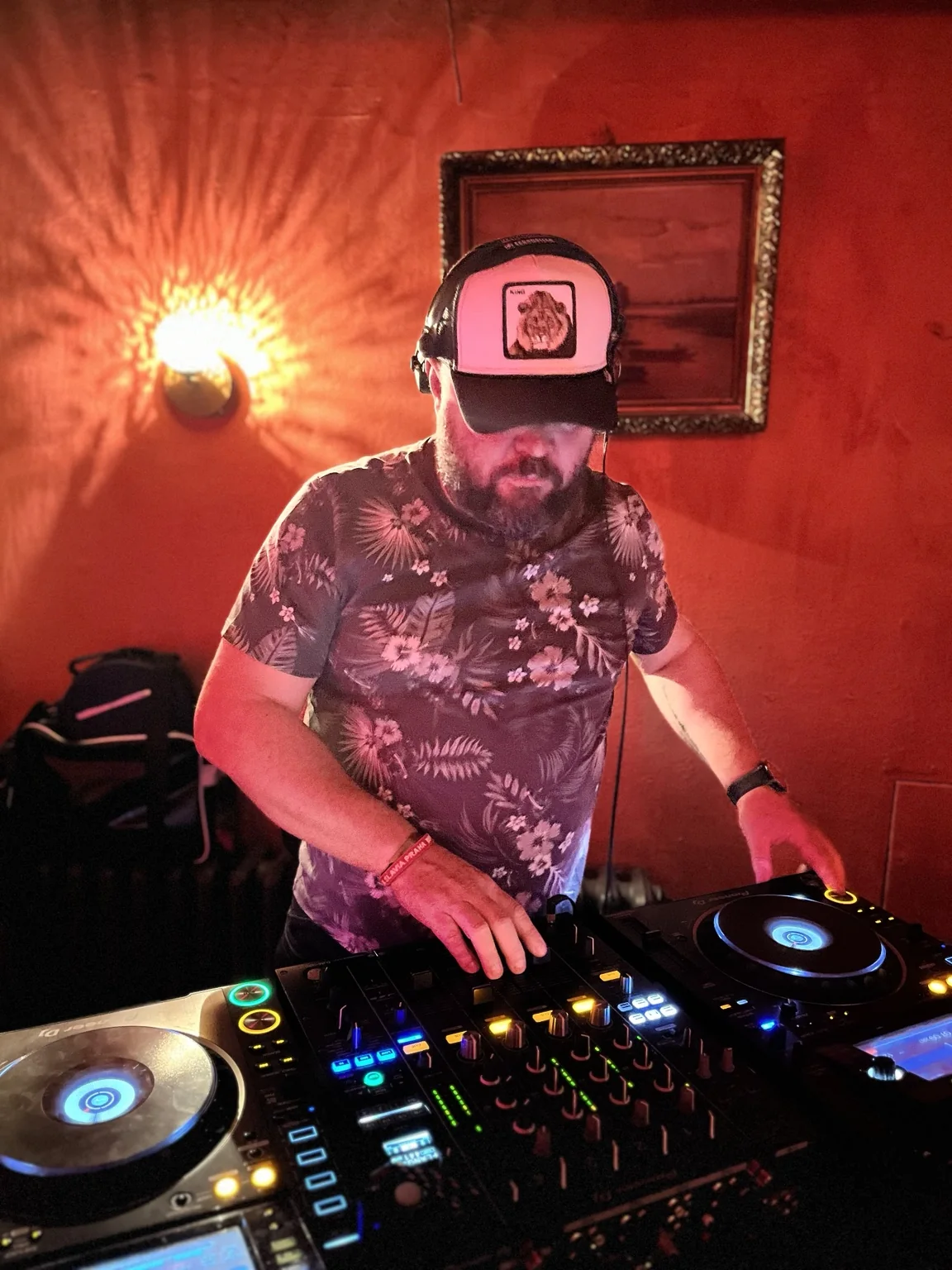 Matt Walli performing in a red-lit venue