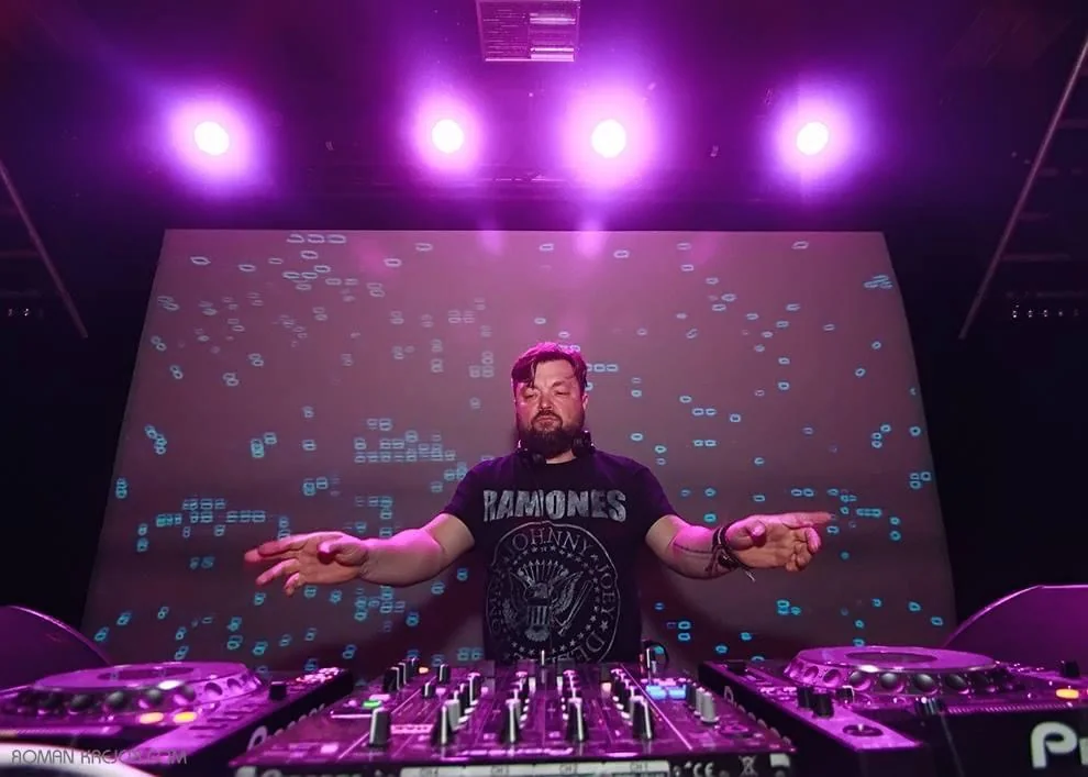 Matt Walli behind the decks under purple lighting