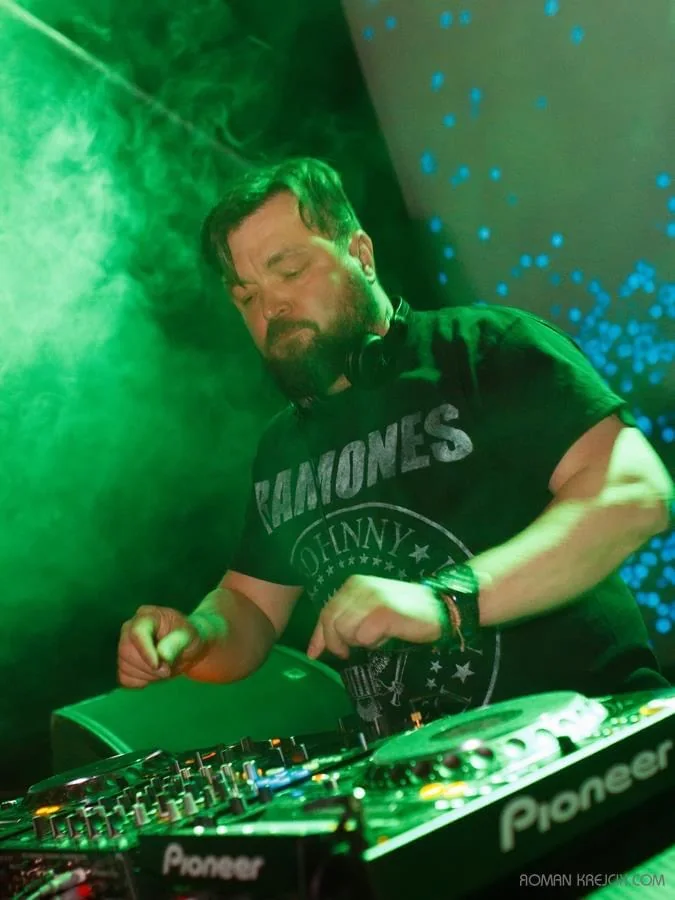 Matt Walli performing in green club lighting